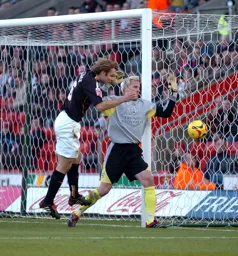 Marcus Heikkinen challenges the Southampton keeper for the ball