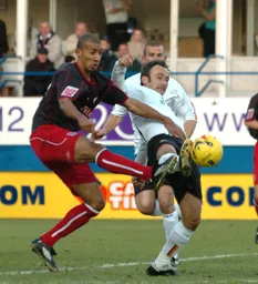 Ahmet Brkovic stretches for the ball with a Stoke defender