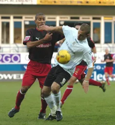 Rowan Vine tussles for the ball with a Stoke player