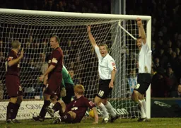 Warren Feeney and Steven Howard celebrate as the ball hits the back of the net
