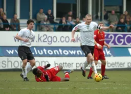 Kevin Nicholls comes away with the ball watched by Stephen Robinson