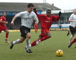 Steven Howard breaks away with the ball with a Watford player in close pursuit