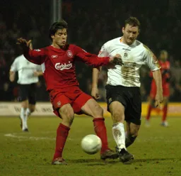 Steven Howard challenges Xabi Alonso for the ball