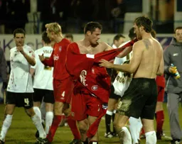 Steven Howard exchanges shirts with Jamie Carragher
