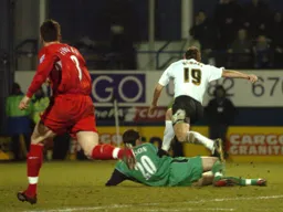 Steven Howard leaps over goalkeeper Carson