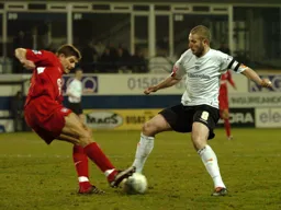 Kevin Nicholls and Steven Gerrard compete for the ball