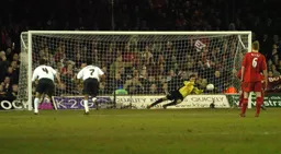 Marlon Beresford dives to save a penalty from Cisse