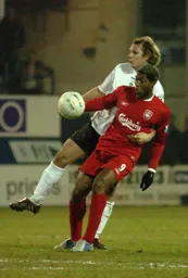 Marcus Heikkinen challenges Cisse for the ball