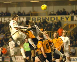Steven Howard leaps above the Wolves defenders and goalkeeper to head home