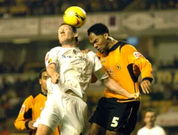 Steven Howard and a Wolves player challenge for a header