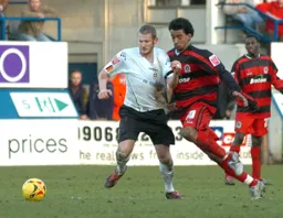 Kevin Nicholls pulled back by Richard Langley as they chase for the ball