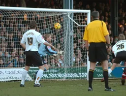 Marcus Heikkinen heads in a goal watched by Steven Howard
