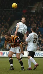 Chris Coyne wins a header watched by Keith Keane