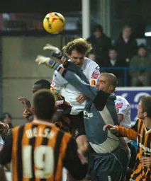 Marcus Heikkinen goes up for a header in a goalmouth melee