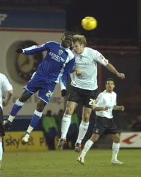 Marcus Heikkinen goes up for a header with a Cardiff player