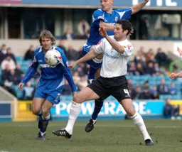 Chris Coyne and a Millwall player tussle for the ball