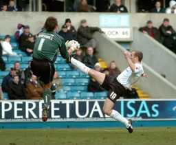 Warren Feeney stretches for the ball with the Milwall goalkeeper