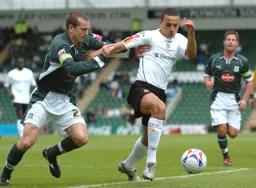Dean Morgan holds off a Plymouth player