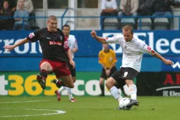 Rowan Vine lines up a shot as Carl Dickinson moves in to block it