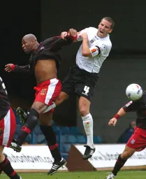 Chris Coyne grabs a handful of Michael Duberry`s shirt