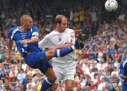 Darren Purse clears the ball away from Sam Parkin