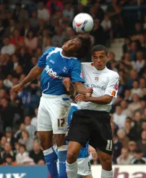 Neil Danns gets the better of Dean Morgan in this heading duel