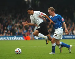 Carlos Edwards skips away from former Hatter Gary McSheffrey