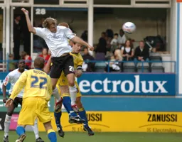 Markus Heikkinen leaps hight to head in Town`s fourth goal.