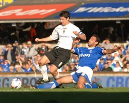 Steve Robinson is tackled by Sylvain Legwinski