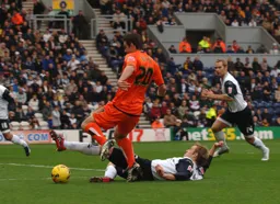 Adam Boyd rides a sliding tackle