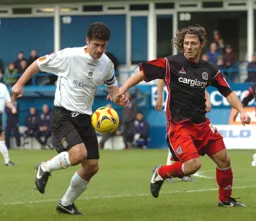 Steve Robinson gets into the panalty area closely watched by Gareth Ainsworth