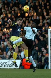 Leon Barnett goes up for a high ball with former Hatter Steve Howard