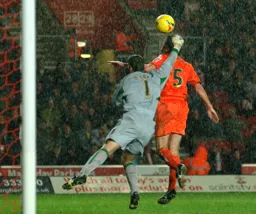 Russell Perrett gets above former Hatter Kelvin Davis to head in Town`s only goal of the game