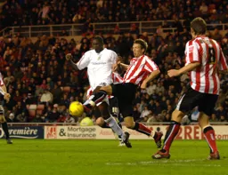 Leon Barnett and Daryl Murphy tussle for the ball