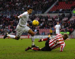 Carlos Edwards goes past Danny Collins