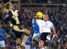 Warren Feeney tries to lob the ball over Maik Taylor