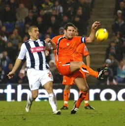 Chris Coyne clears the ball away from Kevin Phillips