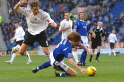 Nils-Eric Johansson goes to ground under Bjorn Runstrom`s challenge