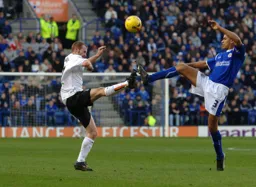 Drew Talbot and Patrick Kisnorbo battle for the ball