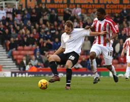 Markus Heikkinen shields the ball away from Salif Diao
