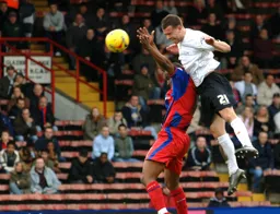 Keith Keane gets above Clinton Morrison to win a header
