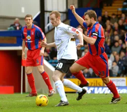Drew Talbot under pressure from Carl Fletcher