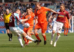 Drew Talbot is baulked by Graham Coughlan