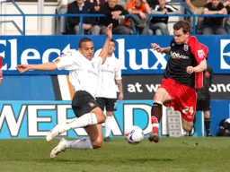 Dean Morgan moves in to block Danny Guthrie