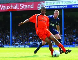 Calvin Andrew keeps the ball away from Peter Clarke