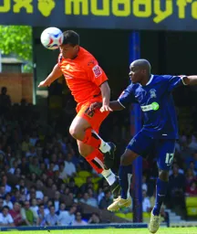 Lewis Emanuel heads the ball away from danger