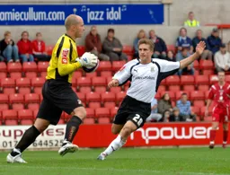 Paul McVeigh is beaten to the ball by the keeper