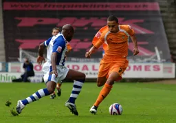 Dean Morgan skips past a Huddersfield defender