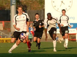 Dave Edwards focuses on the ball with Paul Furlong and Matthew Spring watching on