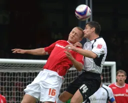 Steve Robinson challenges for a header